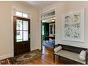 Inviting foyer featuring a hardwood floor, bench seating, and elegant entryway leading to office at 1830 Wilshire Ave, Raleigh, NC 27608