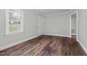 Bright room featuring hardwood floors, freshly painted walls, and a large window that provides natural light at 203 Spring Street St, Louisburg, NC 27549
