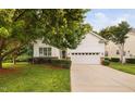 Beautiful home with a well-maintained lawn, mature tree, and a convenient two-car garage at 208 Rockport Ridge Way, Cary, NC 27519