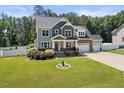 Charming home with well-maintained lawn, manicured shrubbery and three-car garage at 2223 Copper Pond Way, Fuquay Varina, NC 27526