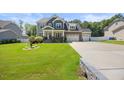 Attractive home featuring a lush green lawn and convenient three-car garage at 2223 Copper Pond Way, Fuquay Varina, NC 27526