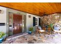 Inviting front porch with stone floor and ceiling, seating area, and stylish entryway at 2707 Anderson Dr, Raleigh, NC 27608