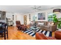 Cozy living room features hardwood floors, a ceiling fan, and comfortable leather seating at 2816 Keck Dr, Burlington, NC 27215