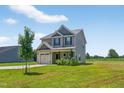 Exterior view of a two-story home with an attached garage and a green lawn at 2998 Matthews Mill Pond Rd, Angier, NC 27501