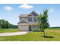 Charming two-story home features a neutral exterior, attached garage, and well-maintained lawn at 2998 Matthews Mill Pond Rd, Angier, NC 27501
