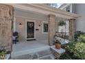 Inviting covered front porch with stylish stone pillars and a cozy hanging bench, perfect for relaxing at 406 E Whitaker Mill Rd, Raleigh, NC 27608