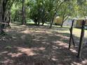 A spacious backyard with tall trees offers plenty of shade and privacy at 417 Sunnyview Rd, Henderson, NC 27536