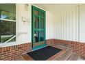 Charming front porch features a green door, brick steps, and classic white trim at 430 Walnut St, Cary, NC 27511