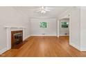 Bright living room features hardwood floors, a decorative fireplace, and neutral paint at 430 Walnut St, Cary, NC 27511