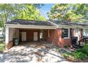 Brick home featuring an attached carport with access stairs to the front door entrance at 4412 Green Spring Dr, Garner, NC 27529