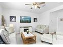 Bright living room with a ceiling fan, neutral paint colors, and ample seating for guests at 444 Campbell Ridge Pl, Wendell, NC 27591