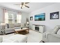 Cozy living room features a comfortable sofa, fireplace, and large TV for relaxing and entertaining at 444 Campbell Ridge Pl, Wendell, NC 27591