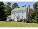 Lovely exterior view of a two story home featuring white siding and a charming green roof at 4822 Nc Highway 98 W, Youngsville, NC 27596