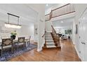 Elegant foyer with hardwood floors, staircase, and open view to living spaces at 501 Ivyshaw Rd, Cary, NC 27519