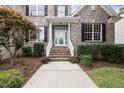 Inviting front entrance with brick stairs, white railings and a glass front door at 501 Ivyshaw Rd, Cary, NC 27519