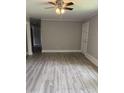 Bright living room featuring modern gray walls, trim and laminate flooring, creating a modern aesthetic at 501 Morgan Ter, Burlington, NC 27217