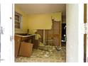 Damaged interior room with exposed walls, missing cabinets, and debris-strewn floor at 503 Edwards Dr, Chapel Hill, NC 27516