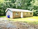 Quaint single-story home featuring brick and siding, with mature trees for added shade and privacy at 525 Locust Rd, Hillsborough, NC 27278