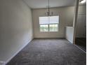 Bright dining room with carpet and a large window providing natural light at 6408 Bunker Hill Dr, Raleigh, NC 27610