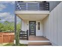 Close up of a charming front porch with stylish railings and a welcoming front door with a wreath at 931 Ramseur St, Durham, NC 27701
