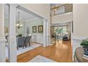Bright foyer with wood floors that opens into a dining room and living area with lots of natural light at 1028 Harpers Ridge Ct, Wake Forest, NC 27587