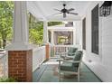 Relaxing front porch with comfortable seating and a ceiling fan for added comfort at 10570 Evergreen Spring Pl, Raleigh, NC 27614