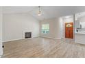 Bright living room with wood floors, fireplace, and a view of the front entrance at 108 Ellsworth Pl, Cary, NC 27511
