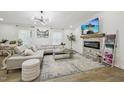 Cozy living room with stone fireplace, plush seating, and stylish decor at 1104 Suterland Rd, Cary, NC 27511