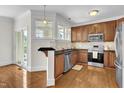 Updated kitchen with stainless steel appliances, granite countertops, and wooden cabinets at 117 Finsbury St, Durham, NC 27703