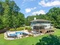 Expansive backyard featuring a swimming pool, hot tub, and a spacious deck at 1209 Ravens Point Cir, Raleigh, NC 27614