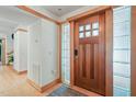 Elegant entryway featuring a beautiful wood door with glass block sidelights at 1209 Ravens Point Cir, Raleigh, NC 27614