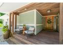 Inviting covered front porch with seating area and natural wood accents at 1209 Ravens Point Cir, Raleigh, NC 27614