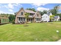 Beautiful two-story home with stone accents, manicured lawn, and landscaping create a welcoming curb appeal at 1212 Gunnison Pl, Raleigh, NC 27609