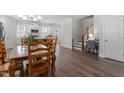 Open dining room with wooden table and chairs, seamlessly connected to the kitchen and living area at 1304 Castlebay Rd, Durham, NC 27703