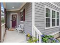 Inviting front porch with cozy seating and colorful flowers, creating a warm welcome to the home at 1304 Castlebay Rd, Durham, NC 27703