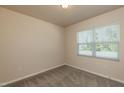Cozy bedroom with neutral walls, carpet flooring, and a window with blinds at 1444 Heron Pond St, Raleigh, NC 27604
