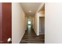 Hallway with wood flooring and neutral walls leading to a bright living space at 1444 Heron Pond St, Raleigh, NC 27604