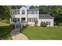 Charming two-story home with a manicured lawn, mature trees, and inviting front entrance at 1524 Wedgewood Dr, Graham, NC 27253