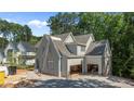 A lovely new construction home with a spacious three-car garage and neutral grey paint at 1529 Lake Adventure Ct, Raleigh, NC 27613