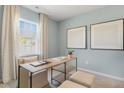 Comfortable office featuring natural light, a modern desk, ottomans, neutral-toned carpet, and soothing wall color at 165 Babbling Creek Dr, Youngsville, NC 27596