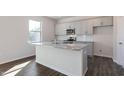 Modern kitchen featuring gray cabinets, a granite island with a sink, and stainless steel appliances at 170 Babbling Creek Dr, Youngsville, NC 27596