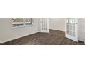Bright bedroom featuring a window and french doors leading to other parts of the home at 195 Babbling Creek Dr, Youngsville, NC 27596