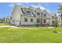 Expansive home features a connected garage, a well-kept lawn, and meticulous landscaping at 201 S Ennis St, Fuquay Varina, NC 27526