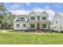 Beautiful two-story home boasts a well-manicured front lawn and a charming, covered front porch at 201 S Ennis St, Fuquay Varina, NC 27526
