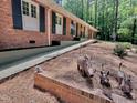Lovely brick house with whimsical yard art and an accessible ramp at 207 Wood Cir, Chapel Hill, NC 27514