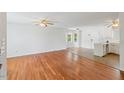 Open-concept living space featuring hardwood floors and a ceiling fan at 209 E Church St, Creedmoor, NC 27522