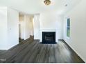 Spacious living room with fireplace, hardwood floors, and plenty of natural light at 27 Stonewall Way, Durham, NC 27704