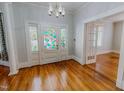 Inviting foyer with hardwood floors, stained glass door, and beautiful trim details at 29 Oak St, Roxboro, NC 27573