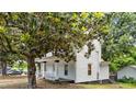 Charming two-story home with a classic design, surrounded by mature trees and a well-maintained lawn at 347 W Trade St, Burlington, NC 27217