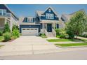 Charming navy blue home featuring a two-car garage and beautifully landscaped front yard at 41 Highveld Ave, Chapel Hill, NC 27516